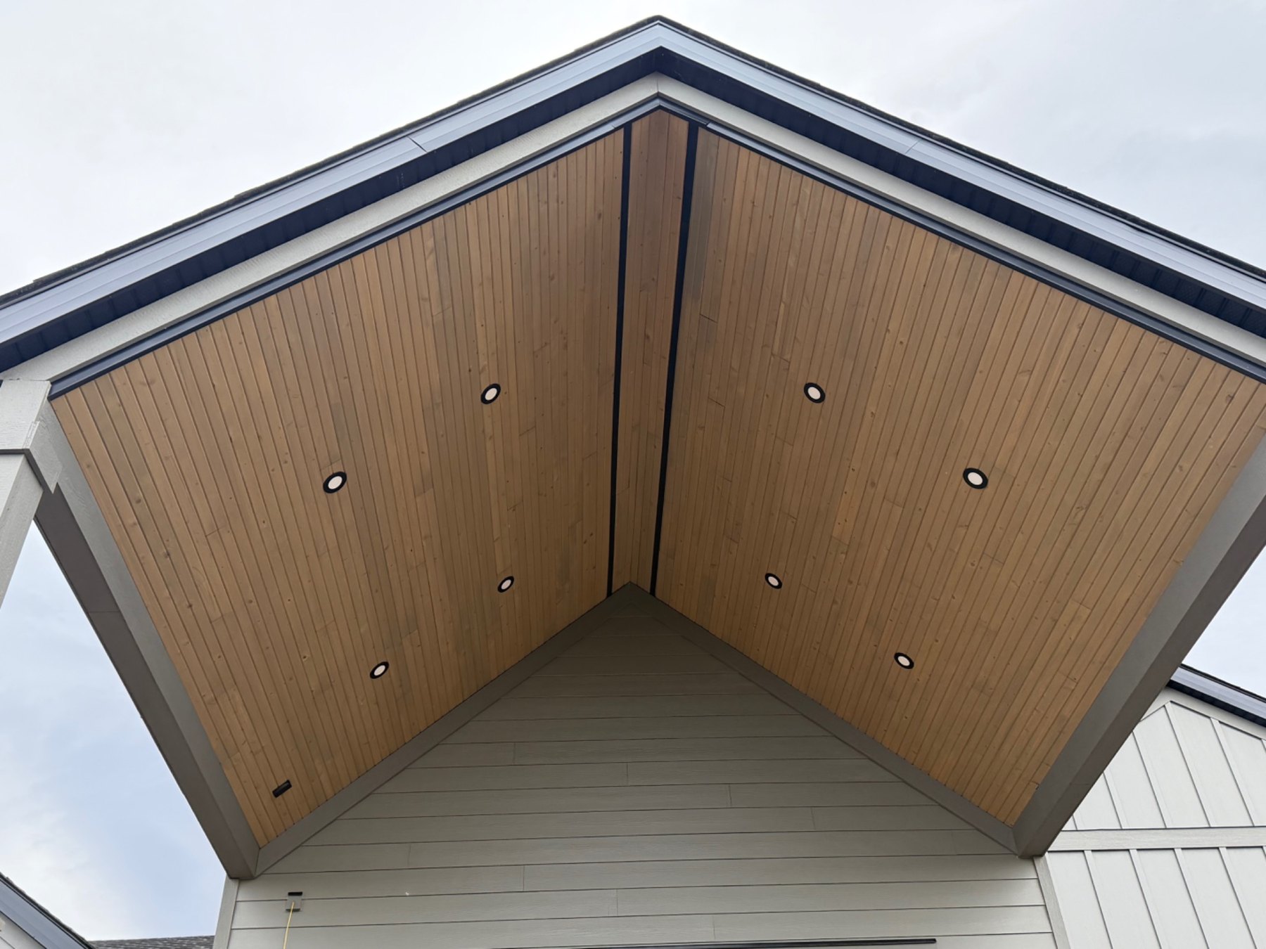 Wood soffit under the covered entry with recessed lights